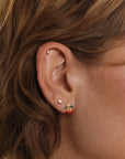 A pair of cherry shaped stud earrings.