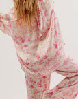 A white and pink pajama set with a cowboy / western themed print.