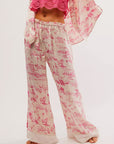 A white and pink pajama set with a cowboy / western themed print.