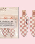 Two checkered hair clips with a white and pinkish terracotta checker print.