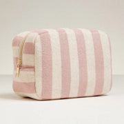 A pink and cream striped terry pouch with a zipper closure.