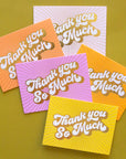 On a green background is a pack of 5 thank you cards in a variety of colors that all read, "Thank You So Much" in white letters and gold foiled outlined.
