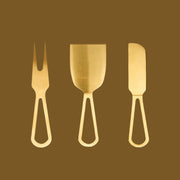A set of gold cheese knives.