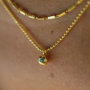 A round beaded necklace with a circle third eye design pendant.