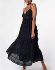 A black lace flowy dress with a v-neck and spaghetti straps that cross in the back.