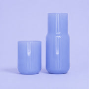 A periwinkle glass carafe.
