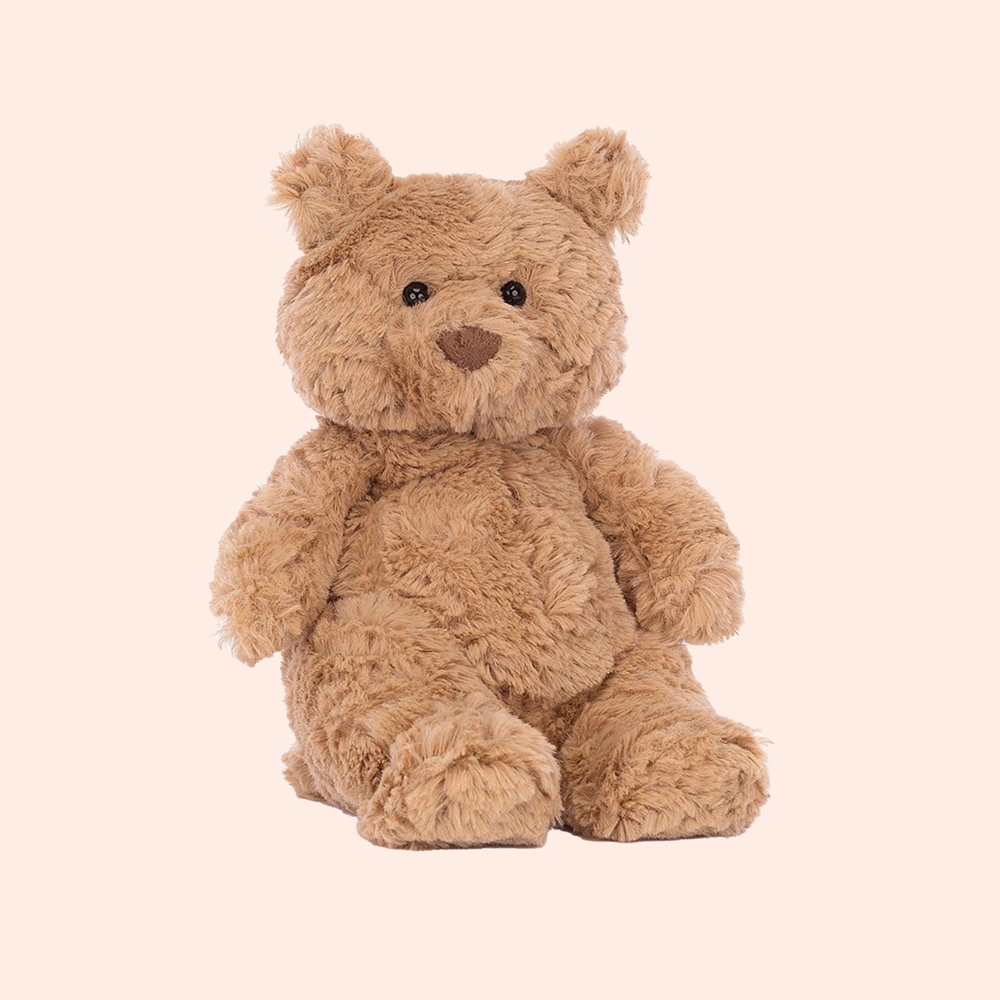 A brown cuddly bear shaped stuffed toy. 