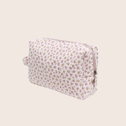 A toiletry bag with a light pink floral print.