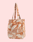 A tan and white canvas tote bag with a front pocket and a paisley pattern.