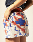 A red and blue geometric print terry cloth shorts.