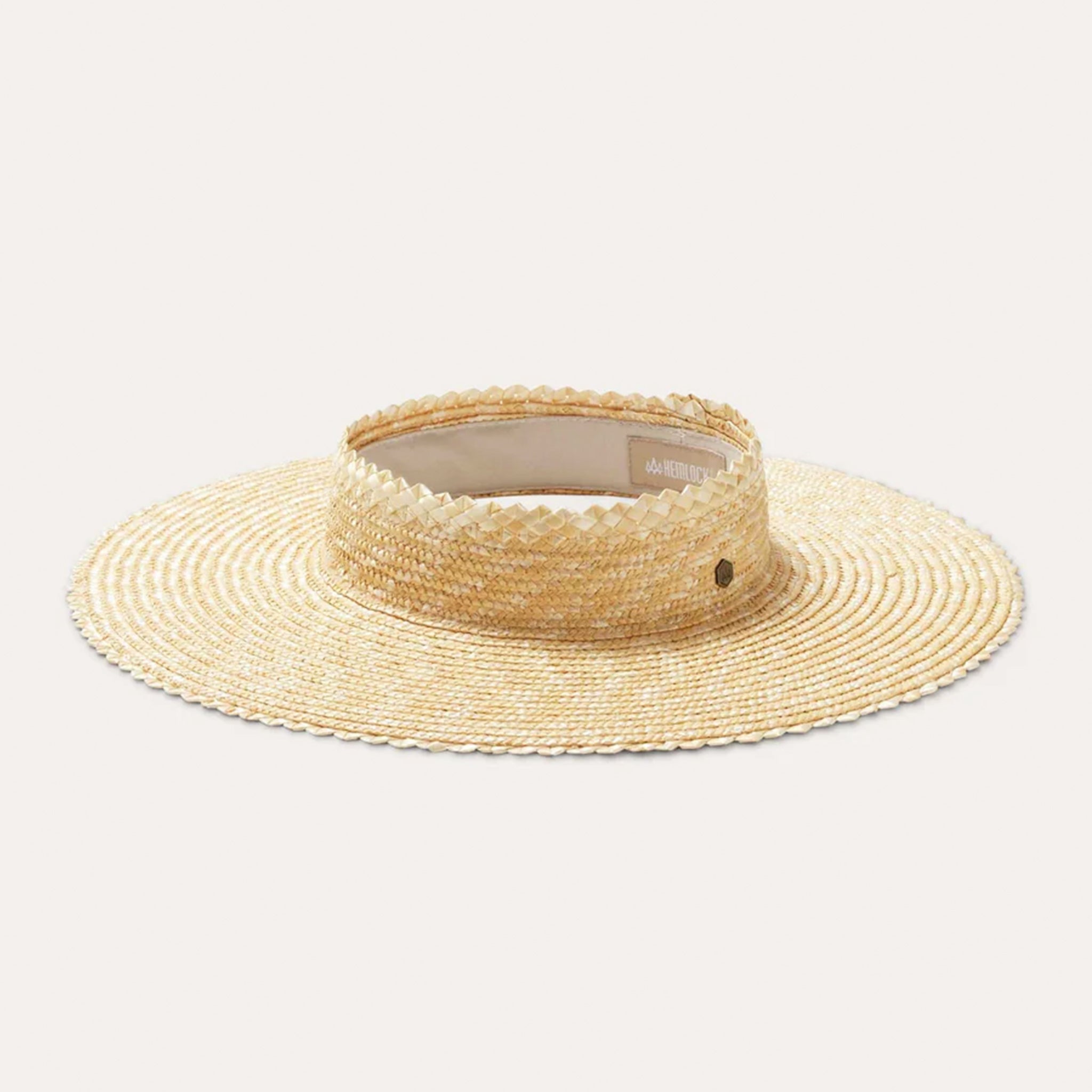 On a white background is a crown less straw sun hat/visor in a natural straw material.