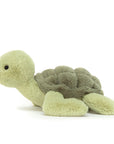 On a white background is a light green turtle stuffed animal.
