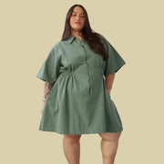 A sage green short utility dress.