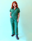 A green short sleeve jumpsuit with a zipper up the front.