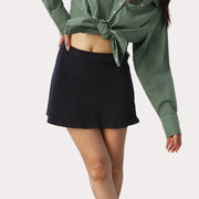 A black waffle knit skort with built in shorts and a pocket.