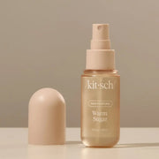 A bottle of hair perfume with text that reads, 'kit-sch hair perfume warm sugar'.