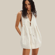 An off white short romper with a vneck tie detail.