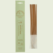 A pack of 20 incense sticks in mint packaging sit on a mint colored background. The name on the packaging is "white sage".