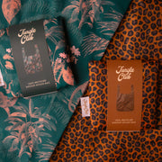 A reusable bag duo with one leopard print and one green with a peach tropical print.
