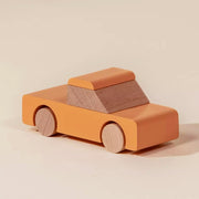 An orange wooden pickup truck shaped toy.