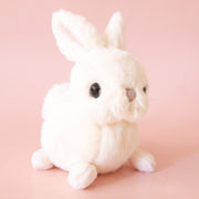 A white bunny shaped stuffed animal.