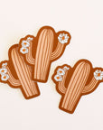 Three salmon pink cactus stickers with cactus flowers on each arm.