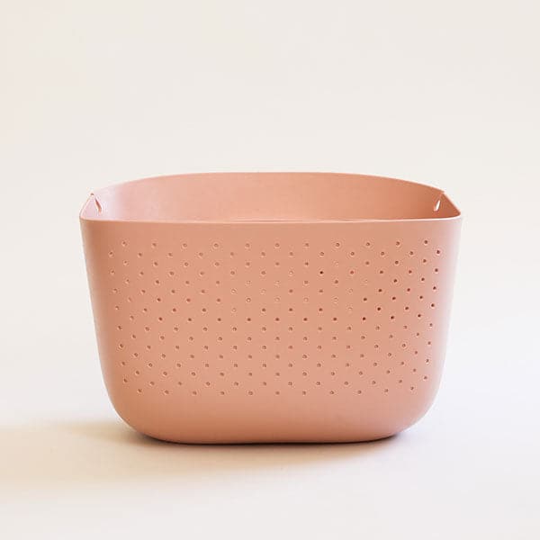 A self watering planter with a BPA free plastic material and a rounded rectangle shape and an opening at the top for a plant. There are small circle holes in the front for ventilation.
