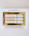On a cream background is a set of three different flavored sugar cubes made for instant mimosa cocktails. The packaging reads, "Teaspressa Instant Mimosa Cocktail Kit".