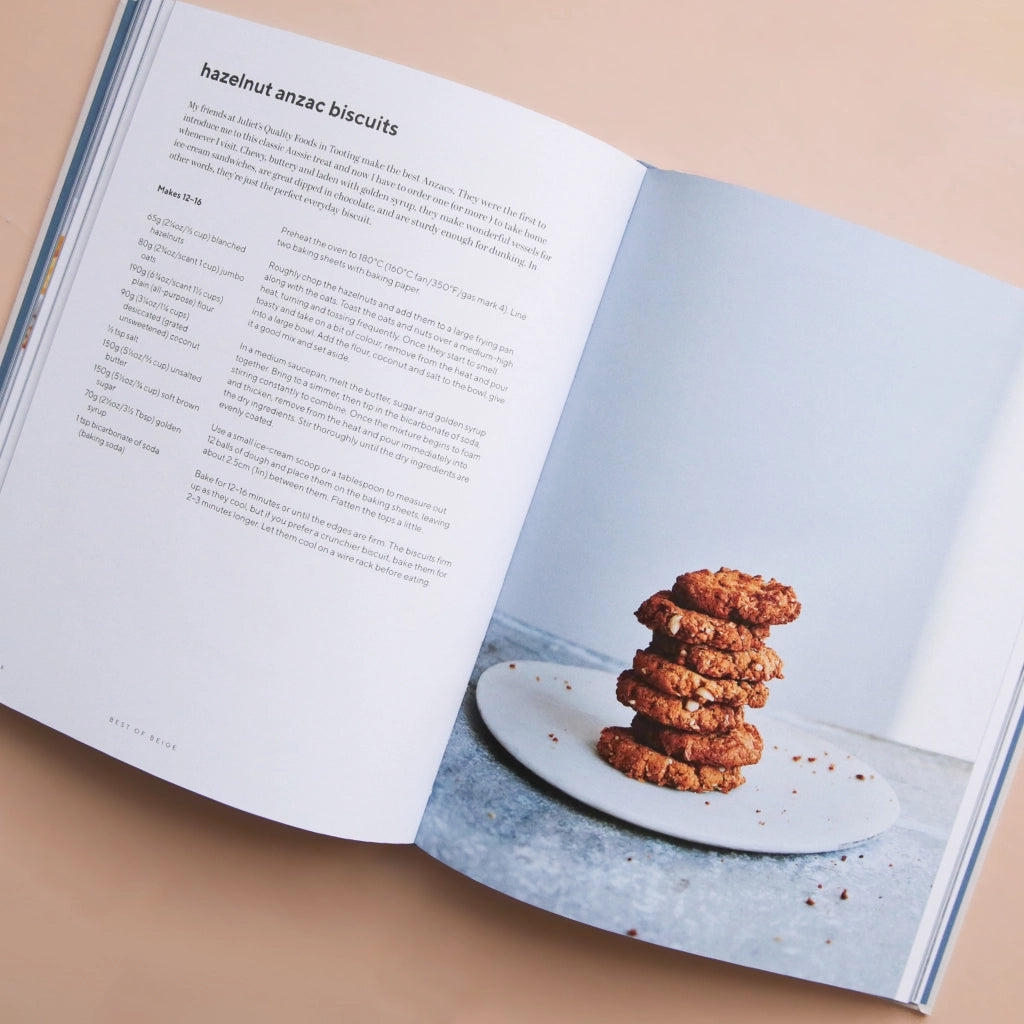 A white book cover with a photograph of a chocolate cake being cut along with the title that says, "a good day to bake" in light blue font.