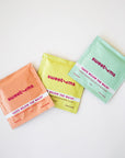 Individual packets of intimate cleaning wipes. Each scent has a different color packaging and this pina colada flavor is yellow.