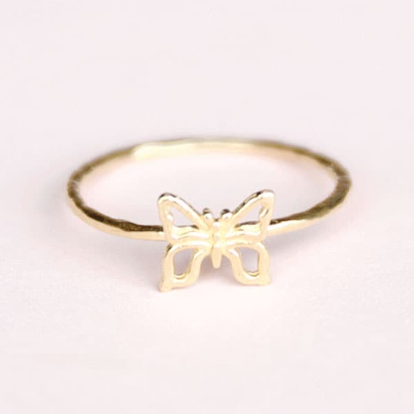 A super thin gold ring with a butterfly outline on top.