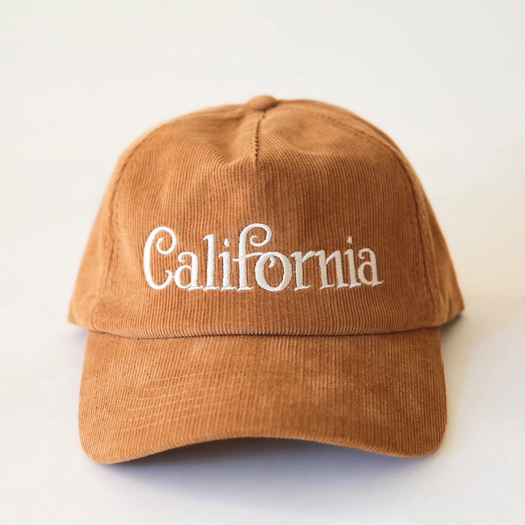 A burnt orange corduroy baseball hat with "California" written on the front along with an adjustable snapback feature.