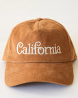 A burnt orange corduroy baseball hat with "California" written on the front along with an adjustable snapback feature.