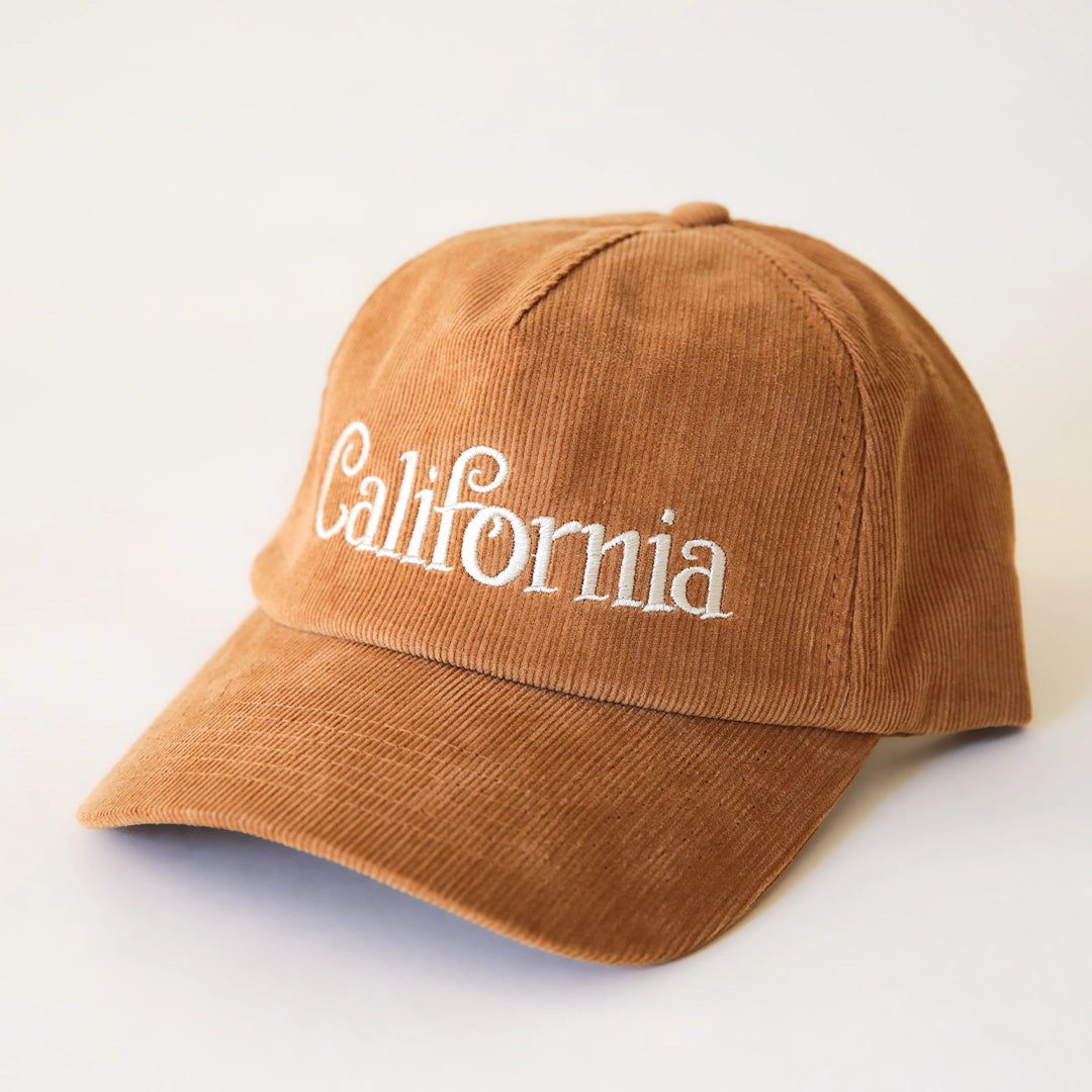 A burnt orange corduroy baseball hat with &quot;California&quot; written on the front along with an adjustable snapback feature.