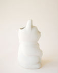 A ceramic lucky cat vase in white with its paw up in the waving position.