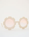 White flower sunglasses with a pink lens.