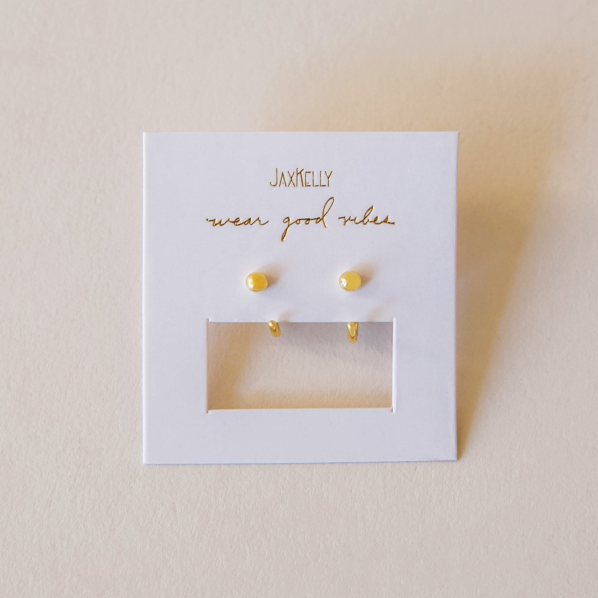 Tiny hoops with a gold sphere on one end, allowing it to have no clasp.