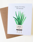On top of a dark brown envelope is a white card. In the middle of the card is a water color painting of a round tan pot sitting on top of a black stool. There is face painted on the front of the pot. Inside the pot is a tall green plant. At the top is black text that reads ‘happy birthday pothead.’