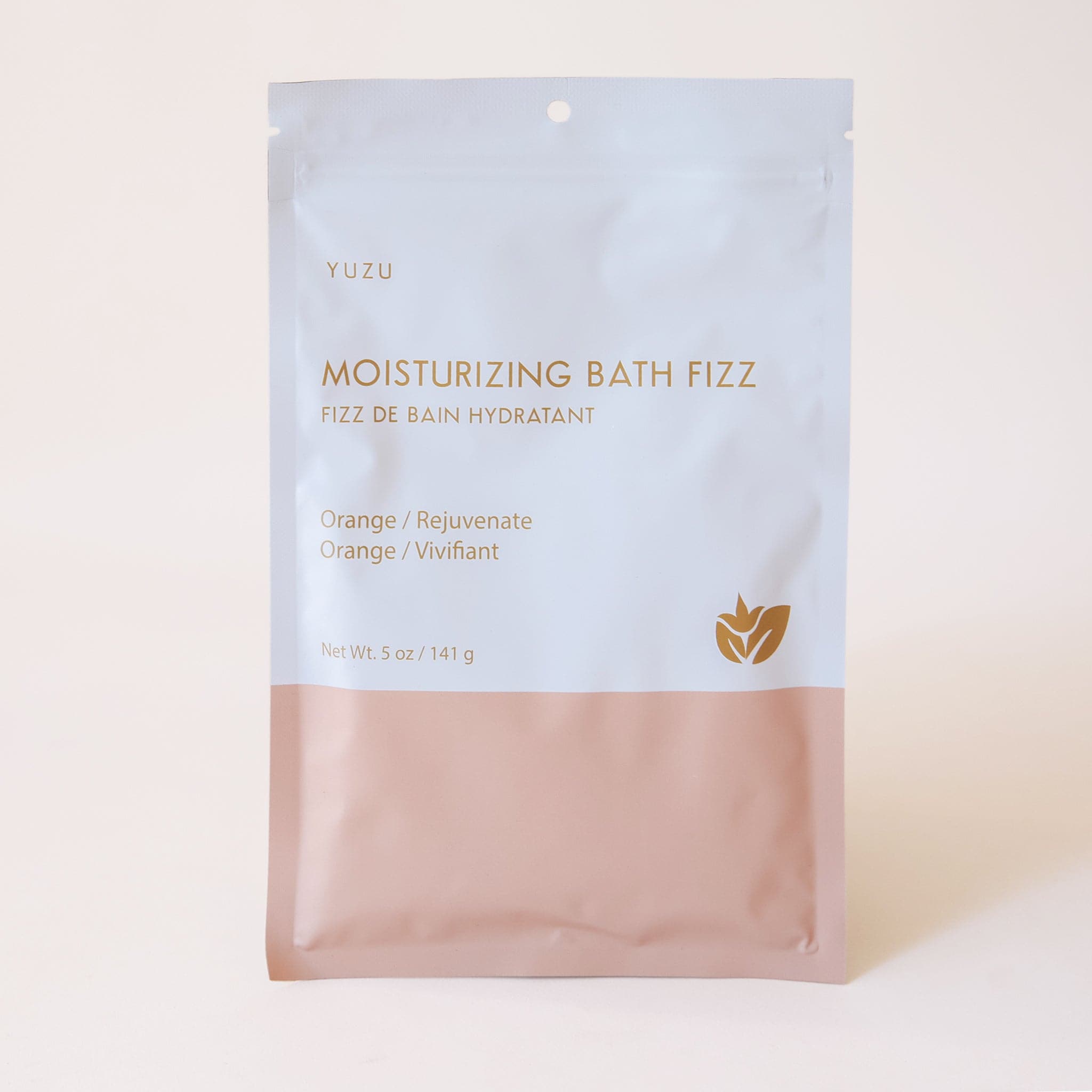 This bath fizz is packaged in a resealable white and pink envelope with gold writing that reads, &quot;Moisturizing Bath Fizz, Orange / Rejuvinate&quot;