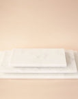 Three white marble trays in different rectangular sizes. Each tray sold separately.