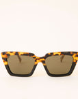 Pair of two toned tortoise and black sunglasses with a geometric cat eye frame shape and dark grey lenses.