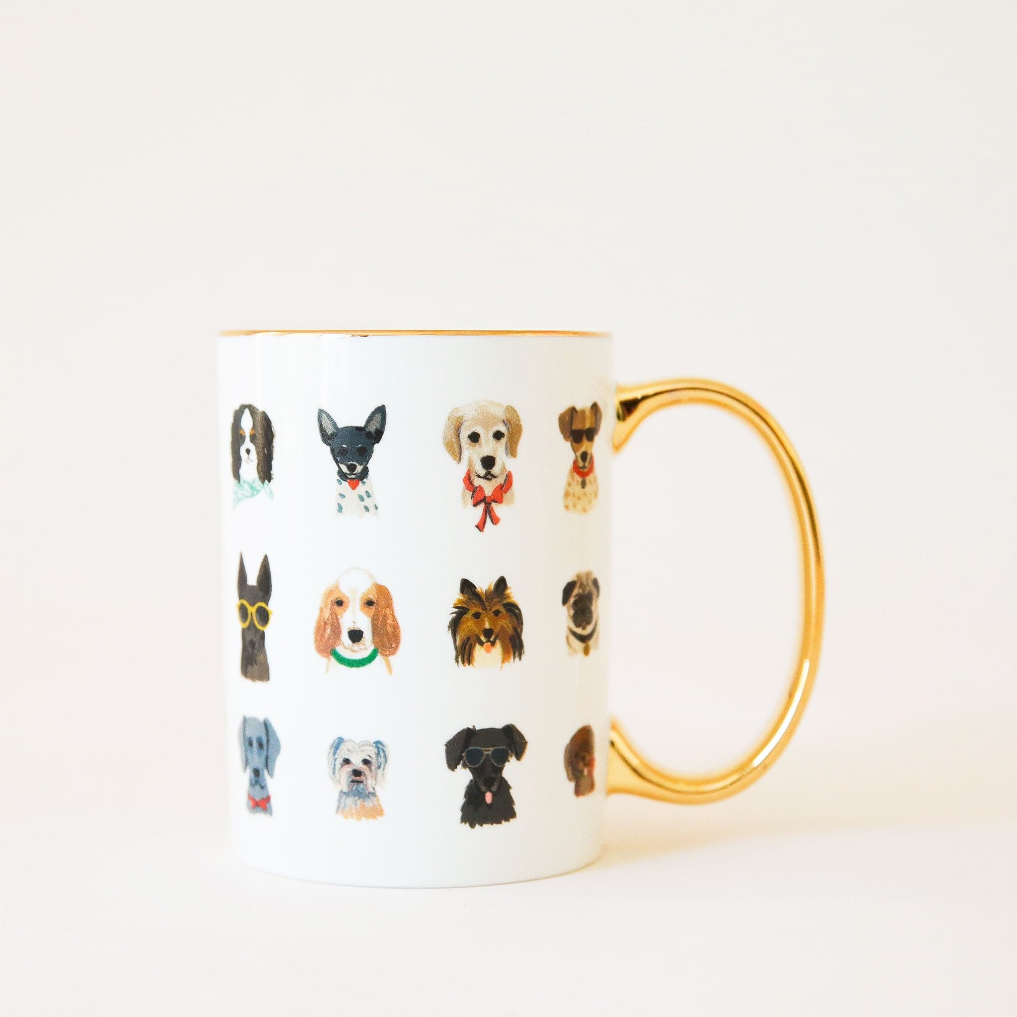 White ceramic mug covered in dog portraits or various breeds dressed in a mix of glasses and bow ties. The mug has a reflective gold handle and rim. 