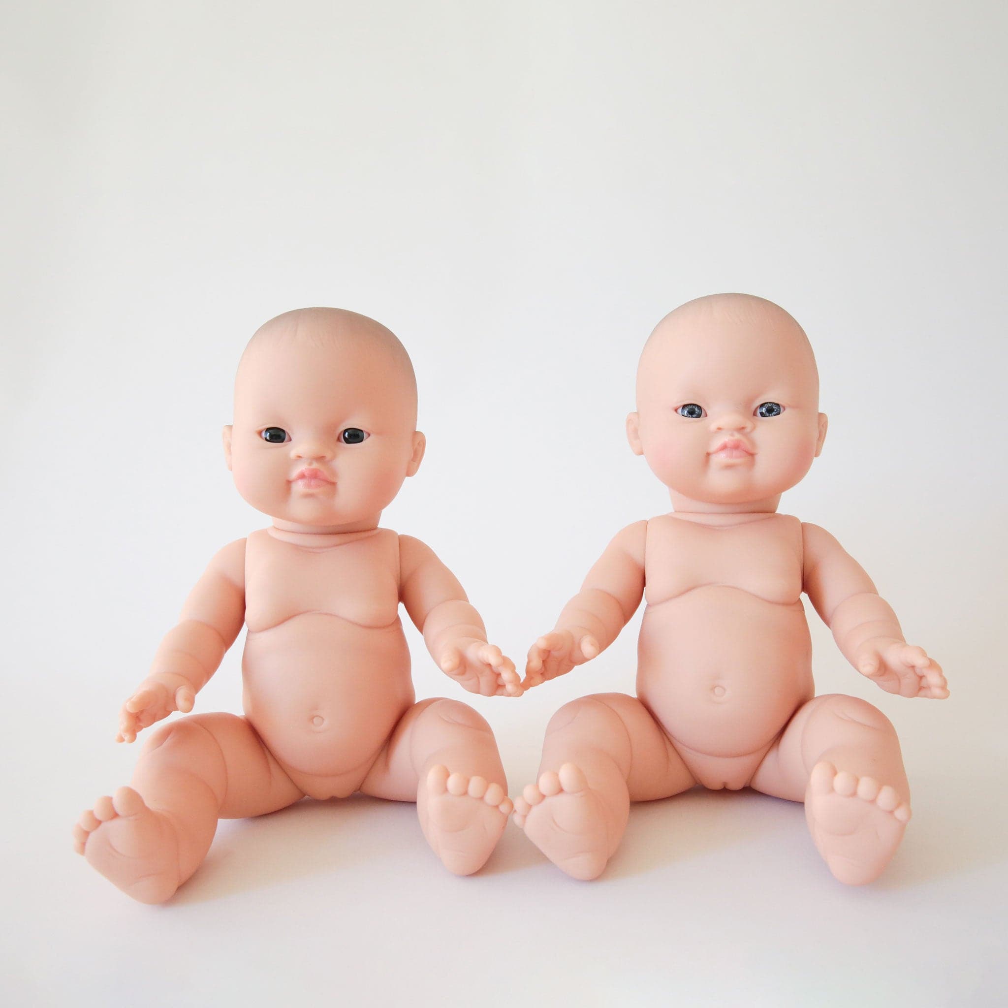 Two options of the baby dolls shown here, one with lighter blue eyes and the other with dark brown eyes.