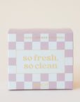 A box of shower steamers in a packaging with pink and white checkered and light yellow text that reads, "So Fresh, So Clean".