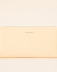 On a cream background is a light yellow zip wallet with silver detailing and "Matt & Nat" written tiny on the front of the wallet.
