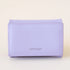 On a cream background is a lavender colored squares wallet with a folding detail and tiny text on the bottom of the front that reads, "Matt & Nat". 