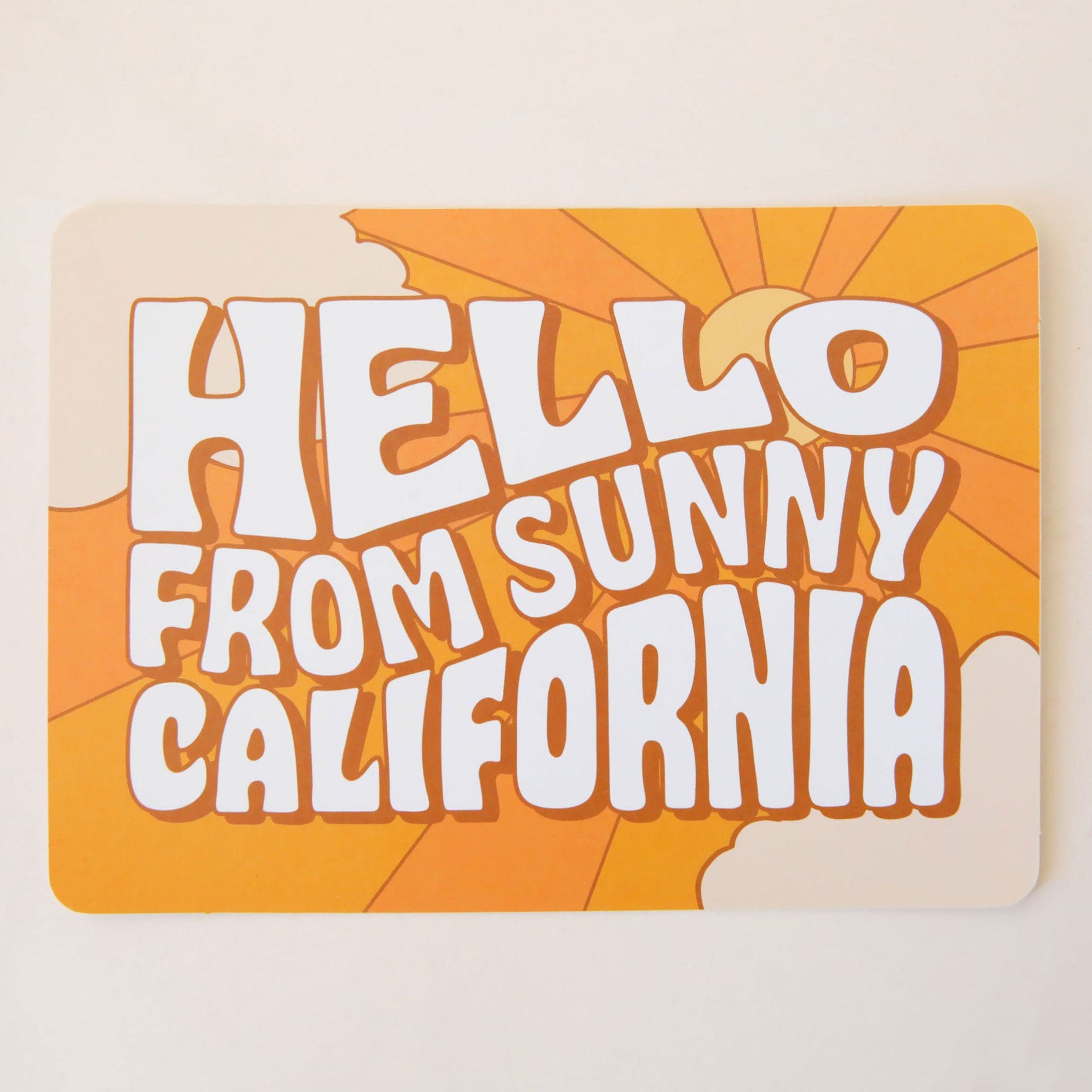 An orange postcard with 70&#39;s style text that reads, &quot;Hello From Sunny California&quot;. 