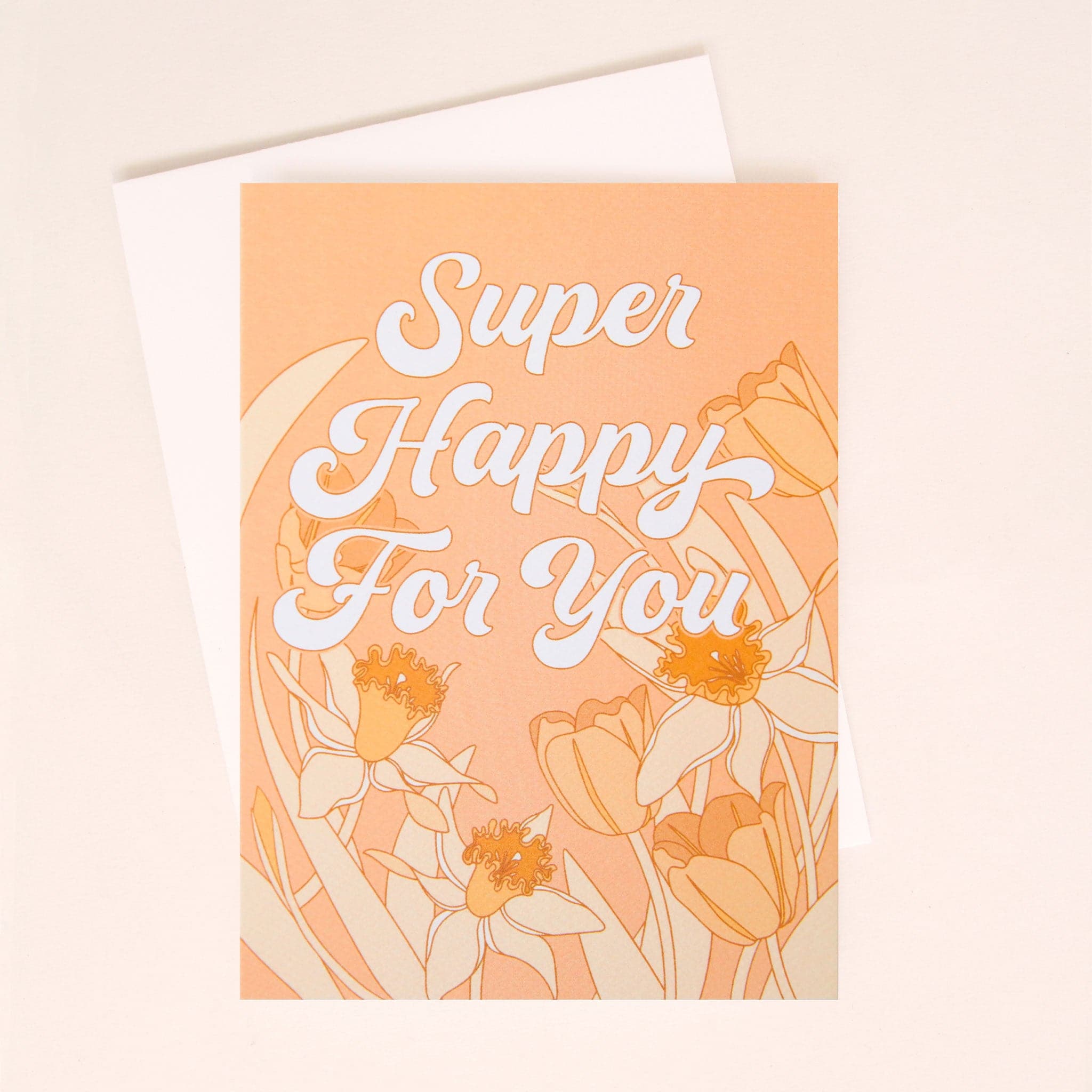 A peach colored card with a white envelope and white bubble cursive text that reads, &quot;Super Happy For You&quot; along with tulip and daffodil illustrations on lining the middle and bottom.