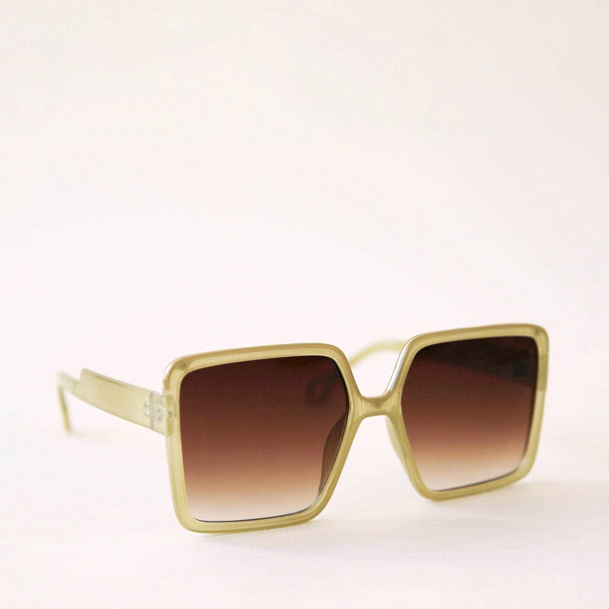 70&#39;s inspired square sunglasses with an olive green frame and a brown lens.