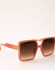 70's inspired square sunglasses with an oversized cognac colored frame and a brown lens.